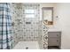 Clean bathroom, featuring patterned tile shower and vanity at 1325 W North B St, Tampa, FL 33606