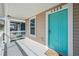 Inviting front porch with teal door and white railing at 1325 W North B St, Tampa, FL 33606