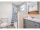 Updated bathroom with patterned tile shower and grey vanity at 1325 W North B St, Tampa, FL 33606