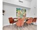 Bright dining area with a wood table and orange chairs at 10404 White Lake Ct # 10404, Tampa, FL 33626