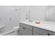 Contemporary bathroom with a walk-in shower and grey vanity at 5104 W Evelyn Dr, Tampa, FL 33609