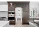 Kitchen with custom cabinetry, walk-in pantry, and a view into a sunlit hallway at 5104 W Evelyn Dr, Tampa, FL 33609
