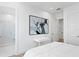 Bright bedroom with a modern art piece and ensuite bathroom access at 5104 W Evelyn Dr, Tampa, FL 33609