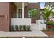 Modern house entrance with stone steps and landscaping at 5104 W Evelyn Dr, Tampa, FL 33609