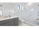 Contemporary bathroom with a glass shower and gray vanity at 5104 W Evelyn Dr, Tampa, FL 33609