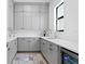 Butler's pantry with grey cabinetry, quartz countertops, and wine cooler at 5104 W Evelyn Dr, Tampa, FL 33609