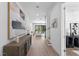 Bright hallway with hardwood floors and modern art at 5104 W Evelyn Dr, Tampa, FL 33609