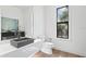 Modern bathroom with a floating concrete sink and a large window at 5104 W Evelyn Dr, Tampa, FL 33609