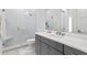 Modern bathroom with a large shower and gray vanity at 5104 W Evelyn Dr, Tampa, FL 33609