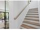 Modern staircase with wood treads and metal railing at 5104 W Evelyn Dr, Tampa, FL 33609