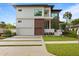 Modern house exterior with a two-car garage at 5104 W Evelyn Dr, Tampa, FL 33609