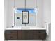 Modern bathroom with a floating vanity and large mirror at 5104 W Evelyn Dr, Tampa, FL 33609