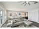 Open-concept living room with gray sectional, dining area, and modern kitchen with stainless steel appliances at 339 55Th Ave, St Pete Beach, FL 33706