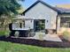 Relaxing backyard oasis with a modern hot tub, brick paver patio, privacy fence, and lush landscaping at 4586 Hickory Oak Dr, Brooksville, FL 34601
