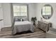 Cozy bedroom with wood floors, natural light, and gray accents at 4586 Hickory Oak Dr, Brooksville, FL 34601