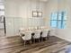 Bright dining room featuring modern lighting fixture, board and batten accent wall, and luxury vinyl flooring at 4586 Hickory Oak Dr, Brooksville, FL 34601