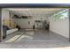 Garage with overhead storage, a workbench area, and epoxy floors at 4586 Hickory Oak Dr, Brooksville, FL 34601