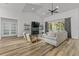 Spacious living room with vaulted ceilings, modern fireplace, floating shelves, luxury vinyl plank flooring, and natural light at 4586 Hickory Oak Dr, Brooksville, FL 34601