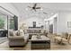 Open concept living room showcasing high ceilings, fireplace, modern furniture, and luxury vinyl plank flooring at 4586 Hickory Oak Dr, Brooksville, FL 34601