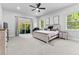 Bright main bedroom featuring luxury carpet, stylish furniture, a ceiling fan, and natural light at 4586 Hickory Oak Dr, Brooksville, FL 34601