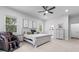 Light-filled main bedroom featuring neutral tones, plush carpet, two windows, and an adjacent en-suite bathroom at 4586 Hickory Oak Dr, Brooksville, FL 34601