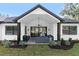 Covered patio with outdoor seating, ceiling fan, and stone flooring at 4586 Hickory Oak Dr, Brooksville, FL 34601