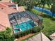 An aerial view shows the screened-in pool and patio of this home backing up to a body of water at 4944 Silverthorne Ct, Oldsmar, FL 34677