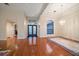 Spacious living room with gleaming hardwood floors, tray ceiling, elegant chandelier, and large windows at 4944 Silverthorne Ct, Oldsmar, FL 34677