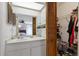 Bathroom with a single sink vanity, wooden shutter door closet, and view into the bedroom at 5325 Bradbury Ct, Tampa, FL 33624