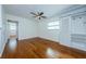 Spacious bedroom with hardwood floors, ceiling fan, and built-in shelving at 6315 35Th N Ave, St Petersburg, FL 33710