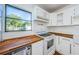 Modern kitchen with white cabinets, wood countertops, and updated appliances at 6315 35Th N Ave, St Petersburg, FL 33710