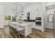 Open concept kitchen with white cabinets, large island, and stainless steel appliances at 4586 Hickory Oak Dr, Brooksville, FL 34601
