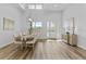 Bright dining room featuring a large wooden table and hardwood floors at 4586 Hickory Oak Dr, Brooksville, FL 34601