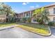 Condo building exterior, featuring landscaping and parking at 1020 85Th N Ave # 223, St Petersburg, FL 33702