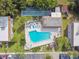 Aerial view of community pool, shuffleboard, and surrounding landscaping at 2750 E Bay Dr # 5F, Largo, FL 33771