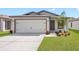 Single-story home with a two-car garage at 15108 Chimney Swift Rd, Weeki Wachee, FL 34614