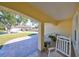 Covered porch with rocking chairs, offering a relaxing view of the front yard at 2313 Towering Oaks Cir, Seffner, FL 33584