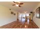 Open living room with hardwood floors, ceiling fan, and access to the dining area at 90 S Highland Ave # 1115, Tarpon Springs, FL 34689