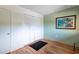 Bedroom with hardwood floors, double closets, and coastal artwork at 90 S Highland Ave # 1115, Tarpon Springs, FL 34689