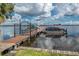 Community boat dock with several boats and access to the lake at 90 S Highland Ave # 1115, Tarpon Springs, FL 34689