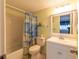 Clean bathroom with shower/tub combo, white vanity, and nautical decor at 90 S Highland Ave # 1115, Tarpon Springs, FL 34689