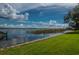 Scenic view of a peaceful lake with lush green grass at 90 S Highland Ave # 1115, Tarpon Springs, FL 34689