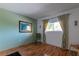 Bright bedroom with wood floors, neutral walls, and window coverings at 90 S Highland Ave # 1115, Tarpon Springs, FL 34689