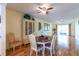 Charming dining room features hardwood floors and a quaint table with chairs at 90 S Highland Ave # 1115, Tarpon Springs, FL 34689