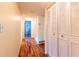 Long hallway with wood floors, ample closet space, and access to bedrooms at 90 S Highland Ave # 1115, Tarpon Springs, FL 34689
