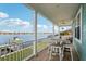 Large covered porch overlooking the water with seating and a table at 339 55Th Ave, St Pete Beach, FL 33706