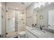 Modern bathroom with white cabinets, granite countertop and a large walk-in shower at 339 55Th Ave, St Pete Beach, FL 33706