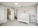 Bedroom with crib, dresser, and access to a full bathroom at 339 55Th Ave, St Pete Beach, FL 33706