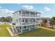 Two-story house with light teal exterior, balconies, and a grassy yard at 339 55Th Ave, St Pete Beach, FL 33706