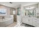 Elegant bathroom with soaking tub, walk-in shower, and double vanity at 339 55Th Ave, St Pete Beach, FL 33706